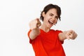 Its you congrats. Smiling cheerful girl pointing fingers at camera, congratulating, inviting you to an event, standing Royalty Free Stock Photo