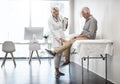 So its your right knee. Full length shot of a mature female doctor working with a senior male patient in her office in Royalty Free Stock Photo