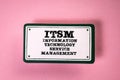 ITSM - Information Technology Service Management. Sticky note with text on a pink background