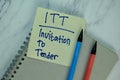 ITT - Invitation To Lender write on sticky note isolated on Wooden Table