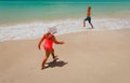 Ittle boy and girl play with water on beach Royalty Free Stock Photo