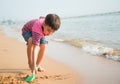 ittle boy playing sand on the beach summer time Royalty Free Stock Photo