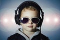 Ittle deejay. funny boy in sunglasses and headphones.child listening music