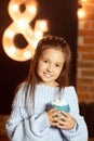 Ittle girl with a cup of cocoa. Girl in a sweater with a cup in her hands. Marshmellow on cocoa. Cozy photo Royalty Free Stock Photo