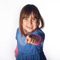 Ittle girl isolated finger pointing at camera with white background. Victory concept