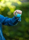 Ittle girl squeezing Earth globe at hand