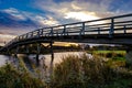 Ittle river landscape with wooden bridge