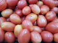 ittle tomatoes on a shelf at the market for sale usable for background Royalty Free Stock Photo