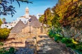 Ityscape of Alberobello town with Edicola Votiva statua Madonnina church, Apulia region, Italy