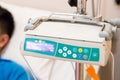 IV infusion pump regulator with patient at background Royalty Free Stock Photo