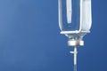 IV infusion set on blue background, closeup. Space for text Royalty Free Stock Photo