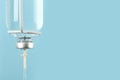 IV infusion set on light blue background, closeup. Space for text Royalty Free Stock Photo