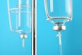 IV infusion set on light blue background, closeup view Royalty Free Stock Photo