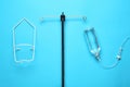 IV infusion set on light blue background, flat lay Royalty Free Stock Photo