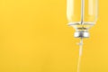 IV infusion set on yellow background, closeup. Space for text