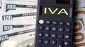 IVA - acronym written on a calculator on the background of banknotes