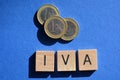 IVA and euro coins on blue background