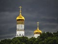 Ivan the Great bell tower in Moscow. Golden domes of the old Cathedral in the Moscow Kremlin before a downpour Royalty Free Stock Photo