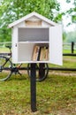 Ivande, Latvia - August 19, 2017: Free white wooden library in the park for sharing books. Outdoor library