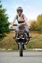 Frontview of young strong biker sitting on sport motorcycle.