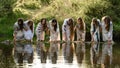 Ivano-Frankivsk, Ukraine July 20, 2023: girls stand in the water, joke and follow wreaths in the water.