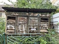 Abandoned rusty and crumpled mailboxes with letter in open boxes