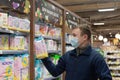 Ivanovo, Russia, February 20, 2022, Editorial. A man in a protective face mask chooses diapers in a store. Father`s Day. Lifestyl