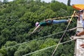 Ivanovsky Bridge, Ukraine - June 21, 2020: Concept of Extreme Sport. The girl is doing rope jumping from the bridge. She is very