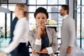 Ive always been determined to standout amongst the crowd. Portrait of a young businesswoman standing in a busy office.