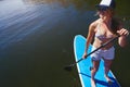 Ive been yearning to explore these waters. an attractive young woman paddle boarding on a lake. Royalty Free Stock Photo