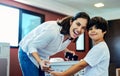Ive got the best little helper. a young attractive mother doing laundry with her son at home. Royalty Free Stock Photo