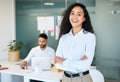 Ive got the best team behind me. an attractive young businesswoman standing in the office with her arms folded while her Royalty Free Stock Photo