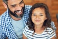 Ive got daddy wrapped around my finger. Portrait of a happy little girl sitting on her fathers lap at home. Royalty Free Stock Photo