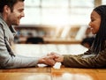 Ive only got eyes for you. an affectionate young couple holding hands while sitting face to face at a table indoors. Royalty Free Stock Photo