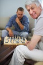 Ive got him thimking. a father and son playing a game of chess together at home. Royalty Free Stock Photo