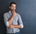 Ive got what it takes to be the best. Portrait of a handsome young businessman posing against a dark background. Royalty Free Stock Photo