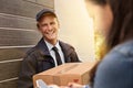 Ive got your package. a young man making a delivery to a woman at her home. Royalty Free Stock Photo