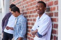 Ive made some cool friends at college. Portrait of a university student on campus with his friends in the background.