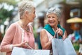 Ive still got a few more bucks to spend. a two senior women out on a shopping spree. Royalty Free Stock Photo