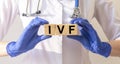 IVF medical concept, acronym on cubes in doctor hands. in vitro fertilisation
