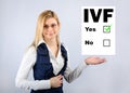 IVF. A woman holds a questionnaire where they chose in vitro fertilization