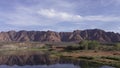 Ivins Lake with red sandstone mountains in the background in Utah