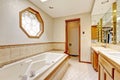 Ivory bathroom interior with miriror and tile wall trim