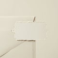 An ivory envelope with a triangular flap is positioned beneath a piece of textured Royalty Free Stock Photo