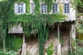 Ivy covered river side building Royalty Free Stock Photo