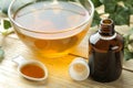 Ivy leaf and syrup in a bottle on a natural wooden table. Production of cough medicine with ivy extract. pharmaceutical industry Royalty Free Stock Photo