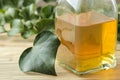 Ivy leaf and syrup in a bottle on a natural wooden table. Production of cough medicine with ivy extract. pharmaceutical industry Royalty Free Stock Photo