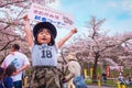 Unidentified young Japanese girl holds sign selling the Kitakami beef