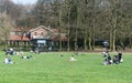 Ixelles, Brussels Belgium - Mixed group of people walking and resting at the green lawns of the Bois de La Cambre city park Royalty Free Stock Photo