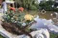 Ixora vase detail in sunny day with lake in background